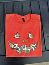 “Orange Gildan Softstyle t-shirt with camo jack-o’-lantern face design”